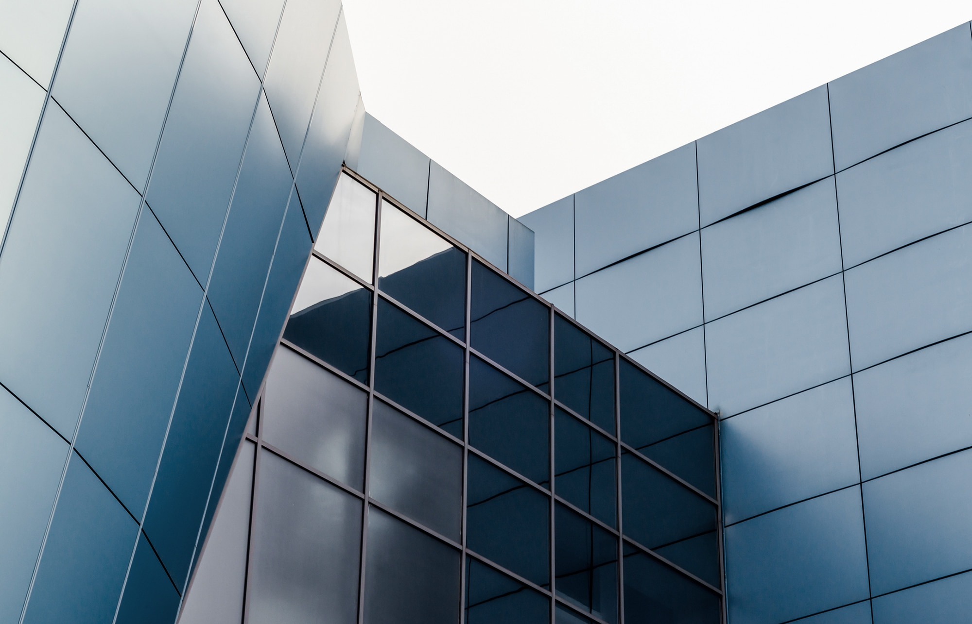 facade of the building with blue panels and reflective surfaces